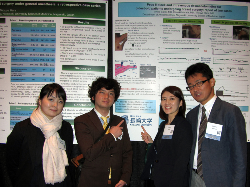 The Nagasaki University team standing proudly in front of their poster Natsuki Mochizuki, Shozo Tominaga, Akiko Sakai, and Hiroaki Murata.